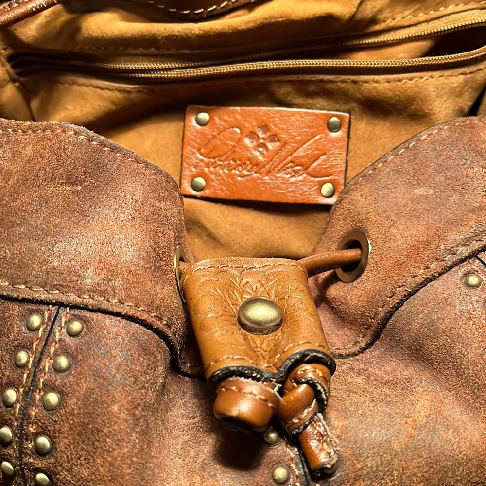 Oil burnished suede shoulder bag with the coordinating wallet.